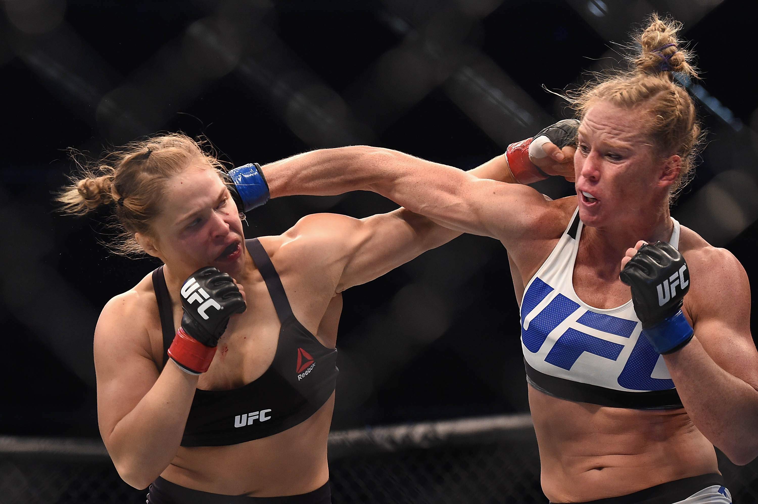 Nov 15, 2015; Melbourne, Australia; Ronda Rousey (red gloves) competes against Holly Holm (blue gloves) during UFC 193 at Etihad Stadium. Mandatory Credit: Matt Roberts-USA TODAY Sports