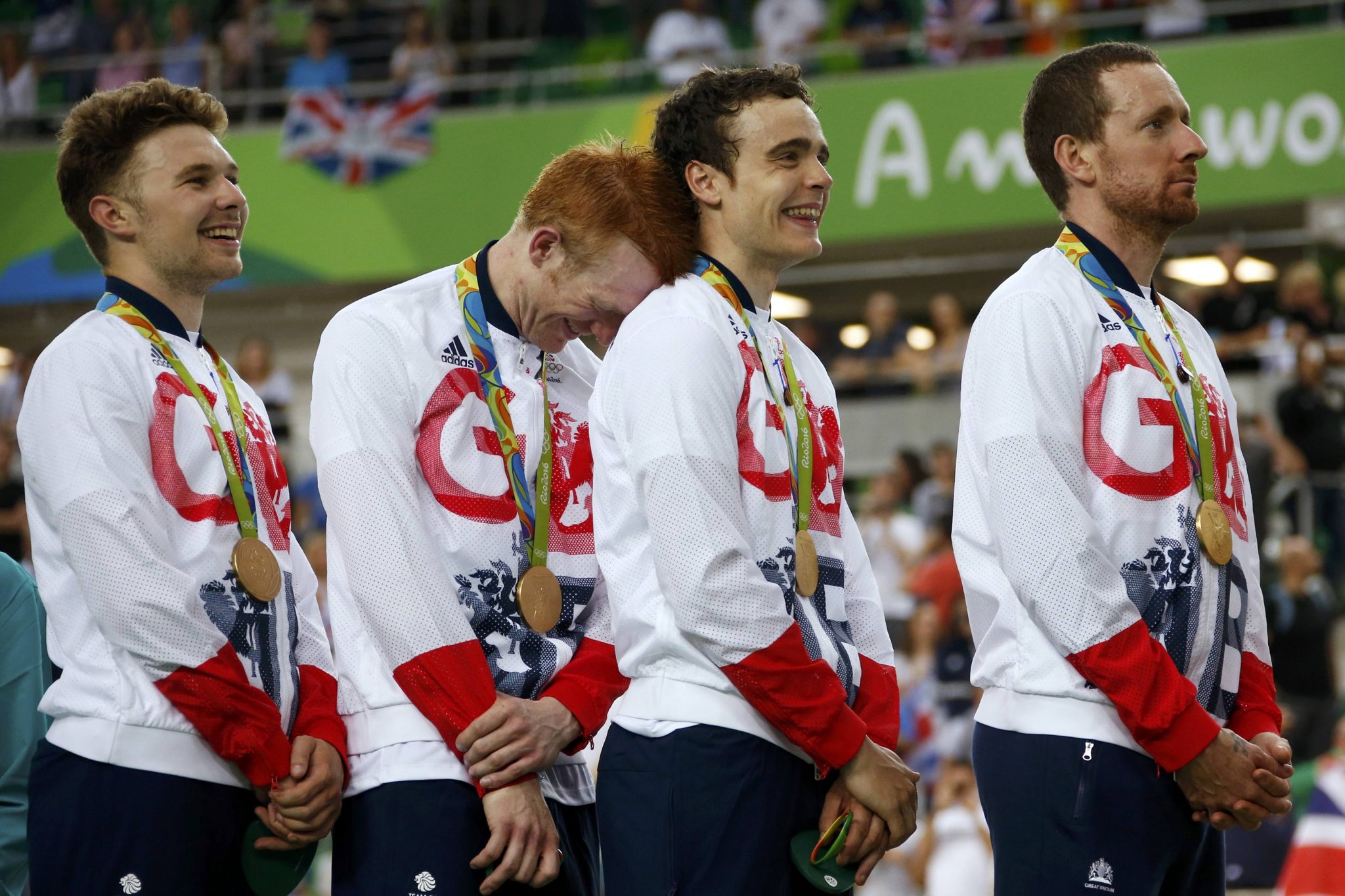 2016 Rio Olympics - Cycling Track - Victory Ceremony - Men's Team Pursuit Victory Ceremony - Rio Olympic Velodrome - Rio de Janeiro, Brazil - 12/08/2016. Owain Doull (GBR) of Britain, Ed Clancy (GBR) of Britain, Steven Burke (GBR) of Britain and Bradley Wiggins (GBR) of Britain react on the podium with the gold medals. REUTERS/Eric Gaillard FOR EDITORIAL USE ONLY. NOT FOR SALE FOR MARKETING OR ADVERTISING CAMPAIGNS.